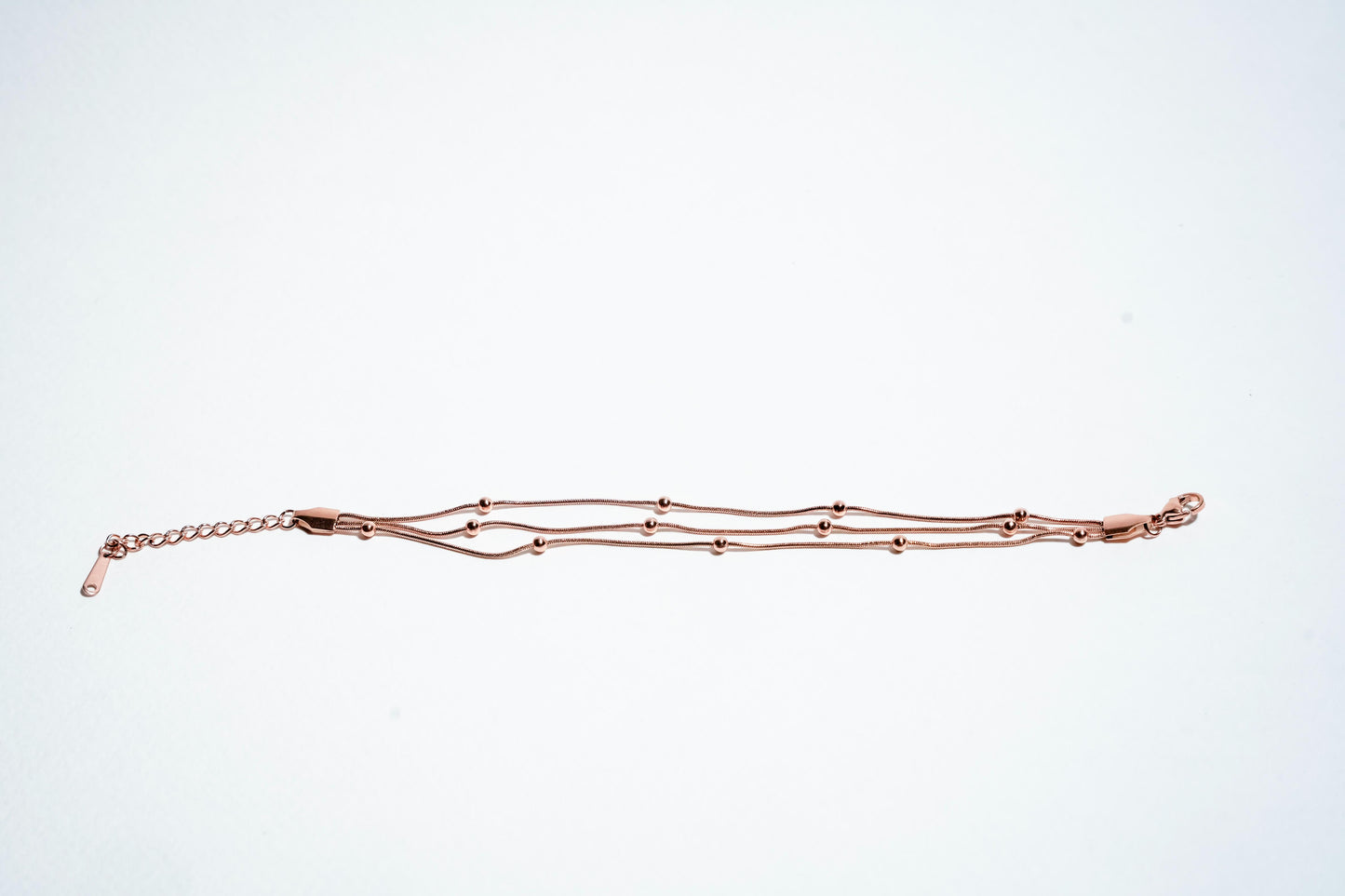 Celestial Harmony: Triple-Strand Rose Gold Beaded Bracelet