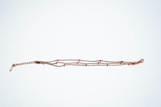 Celestial Harmony: Triple-Strand Rose Gold Beaded Bracelet