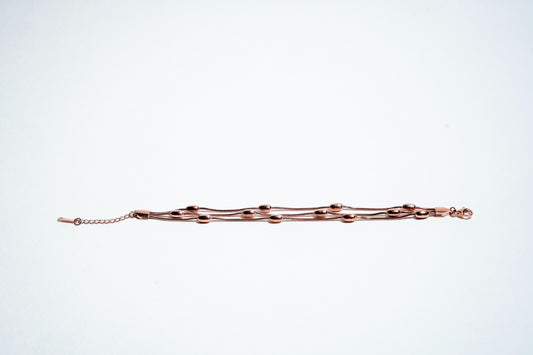Serene Whispers: Triple-Strand Rose Gold Bead Bracelet
