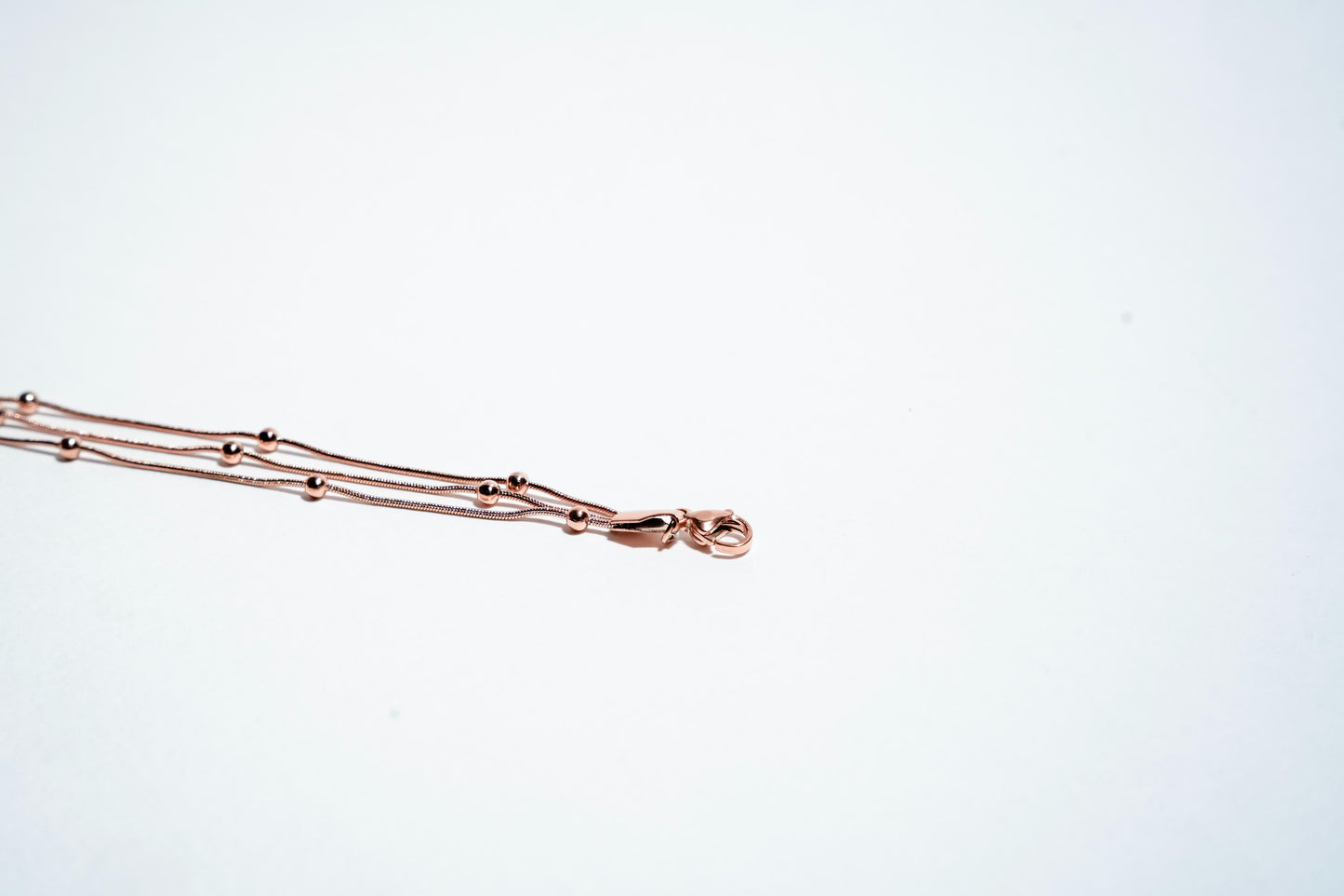 Celestial Harmony: Triple-Strand Rose Gold Beaded Bracelet
